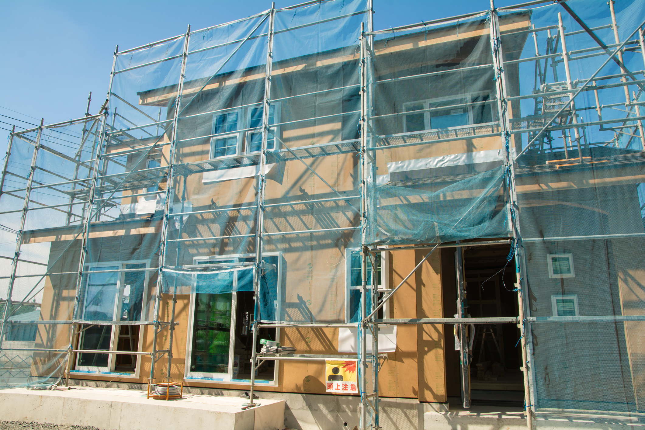Residential housing retrofit project with scaffolding and external wall upgrades to improve insulation and energy efficiency