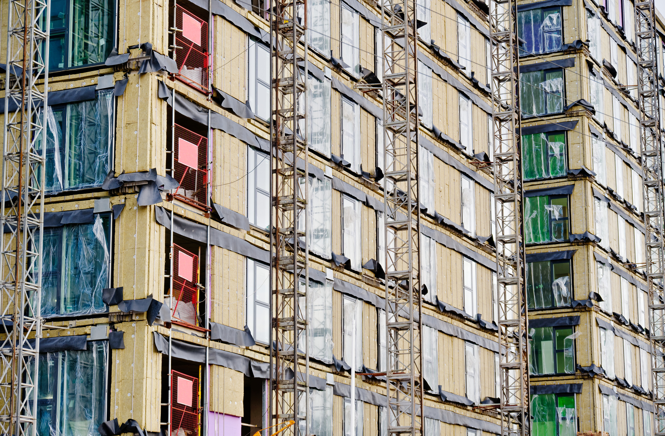 External wall insulation and cladding system being installed on a commercial building to improve thermal performance and energy efficiency